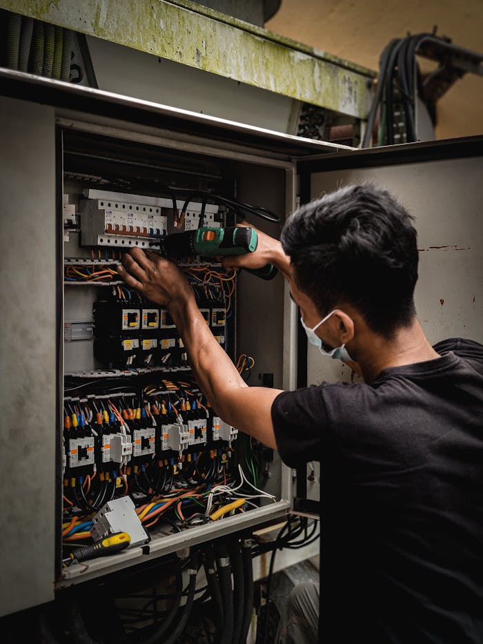 a-man-working-on-the-circuit-breaker-switch-9679179