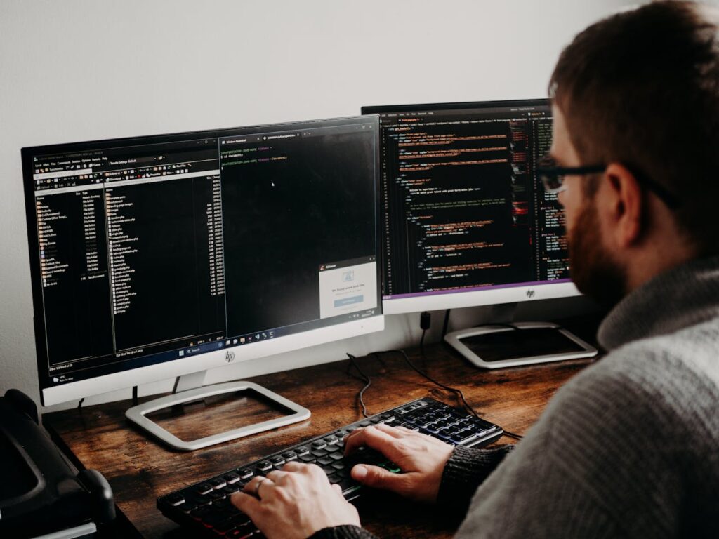 man-working-on-computers-coding-16129724